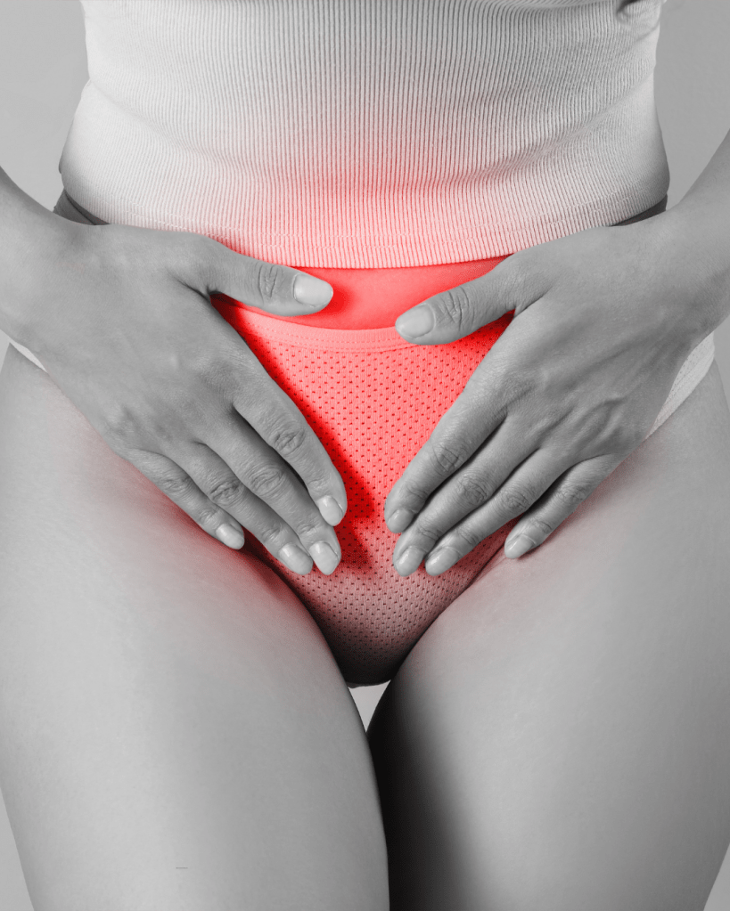 A close-up of a woman's lower abdomen with hands resting on the hips, highlighting the area with a red glow against a black-and-white background.