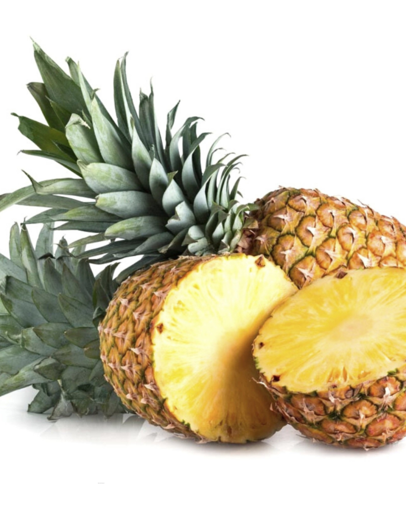 Fresh pineapple with two halves revealing the juicy yellow inside and green spiky leaves.