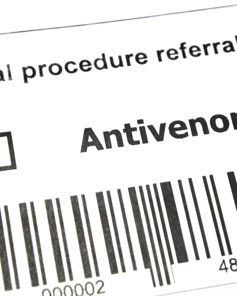 Close-up of a referral label with the word 'Antivenom' and a barcode printed on it.
