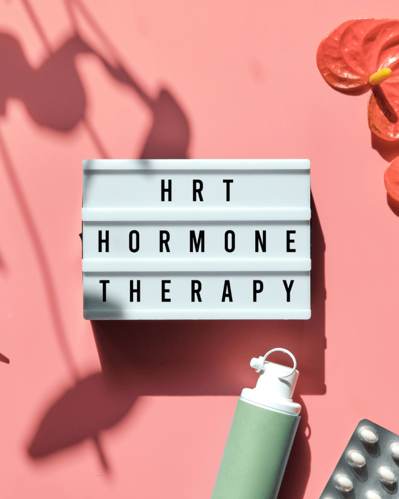 Lightbox with text reading 'HRT Hormone Therapy' on a pink background, surrounded by decorative items like flowers and a green water bottle.